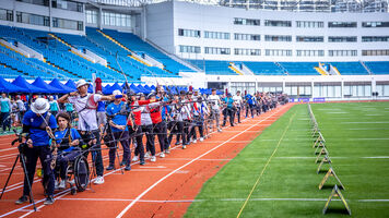 Archers on the shooting line at Yuanshen Stadium.